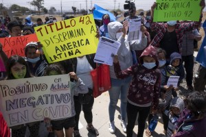 Migrants and asylum seekers protest outside the United States Consulate against Title 42 policy, in Tijuana, Baja California state, Mexico, on May 19, 2022. (GUILLERMO ARIAS/AFP via Getty Images)