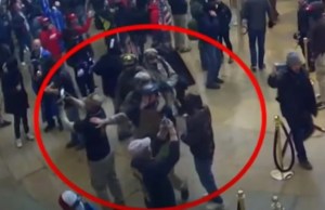 Members of the Oath Keepers stand around and take photos inside the US Capitol on Jan. 6, 2021.