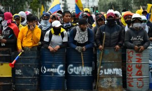 Indigenous men prepare to march in Quito, on 22 June 2022, on the tenth consecutive day of Indigenous-led protests against the Ecuadorean government. Photograph: Rodrigo Buendía/AFP/Getty Images