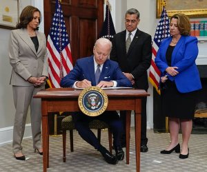 President Joe Biden signs an executive order on abortion access as, from left, Vice President Kamala Harris, Health and Human Services Secretary Xavier Becerra, and Deputy Attorney General Lisa Monaco look on. (Evan Vucci/AP)