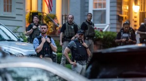 Law enforcement officers stand guard as protesters march past Supreme Court Justice Brett Kavanaugh's home on June 8, 2022, in Chevy Chase, Maryland.  ((Photo by Nathan Howard/Getty Images))