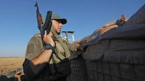 A Turkey-backed fighter looks out from a military position in the Syrian area of Jibrin in Aleppo's eastern countryside, towards the Kurdish-controlled area of Tal Rifaat, on July 19, 2022.  (Photo by BAKR ALKASEM/AFP via Getty Images)