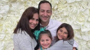 Sid Wolf (C) and his wife, Lindsey (L), pose for a picture with their two daughters. (Courtesy of GoFundMe)