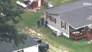 Authorities are seen around a North Carolina home after three deputies were shot while trying to serve paperwork. (WRAL)