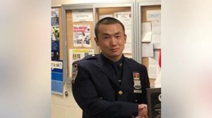 NYPD Officer Baimadajie Angwang is accused of working for the Chinese government by spying on supporters of the free Tibet movement.  (New York Police Department / NYPD 111th Precinct Twitter account)