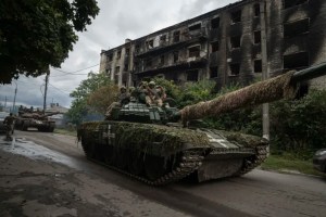 Ukrainian servicemen drive atop a tank in the recently retaken area of Izium, Ukraine, Wednesday, Sept. 14, 2022. (AP Photo/Evgeniy Maloletka)