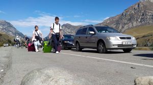 People walk toward the border crossing at Verkhny Lars between Georgia and Russia. Pic: AP