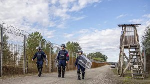 Operational police officers walk along the service route of Hungary's border with Serbia near Roszke, Southern Hungary.   -   Copyright  Tibor Rosta/MTI - Media Service Support and Asset Management Fund