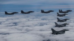In this photo provided by South Korea Defense Ministry, South Korean Air Force's F15K fighter jets and U.S. Air Force's F-16 fighter jets, fly in formation during a joint drill in an undisclosed location in South Korea, Tuesday, Oct. 4, 2022. (South Korea Defense Ministry via AP)