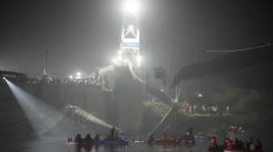 Rescuers on boats search in the Machchu river next to a cable suspension bridge that collapsed in Morbi town of western state Gujarat, India, Monday, Oct. 31, 2022. (AP Photo/Ajit Solanki)
