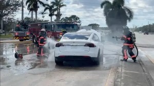 Firefighters attempt to put out a fire started from a waterlogged electric vehicle after Hurricane Ian slammed Florida's west coast. (Jimmy Patronis/Twitter / Fox News)