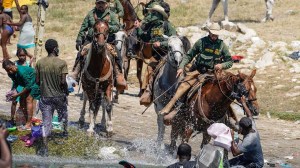U.S. Customs and Border Protection mounted officers attempt to contain migrants as they cross the Rio Grande from Ciudad Acuña, Mexico, into Del Rio, Texas, Sunday, Sept. 19, 2021.  (PAUL RATJE/AFP via Getty Images)