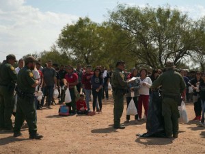Migrants being processed by U.S. Border Patrol after they illegally crossed the Mexican border into Eagle Pass, Texas, in October. (Photo by Allison Dinner / AFP via Getty Images)