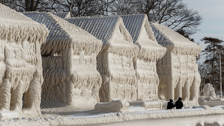 Homes are seen covered in ice in Fort Erie, Ontario, on Wednesday, Dec. 28. (Cole Burston/AFP via Getty Images)