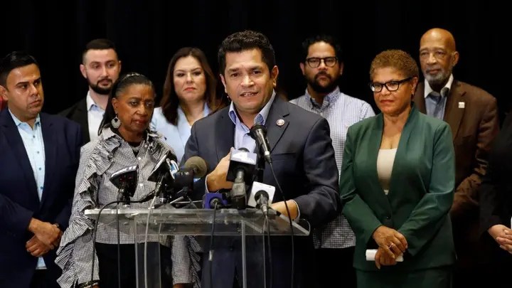 Rep. Jimmy Gomez, center, and mayoral candidate Rep. Karen Bass, second from right, call on civic leaders from all over Los Angeles to initiate a plan of action to address the racist, anti-Black, antisemitic, anti-LGBTQ, anti-Indigenous, anti-Armenian recordings at a press conference on Oct. 21, 2022. (Carolyn Cole / Los Angeles Times via Getty Images)