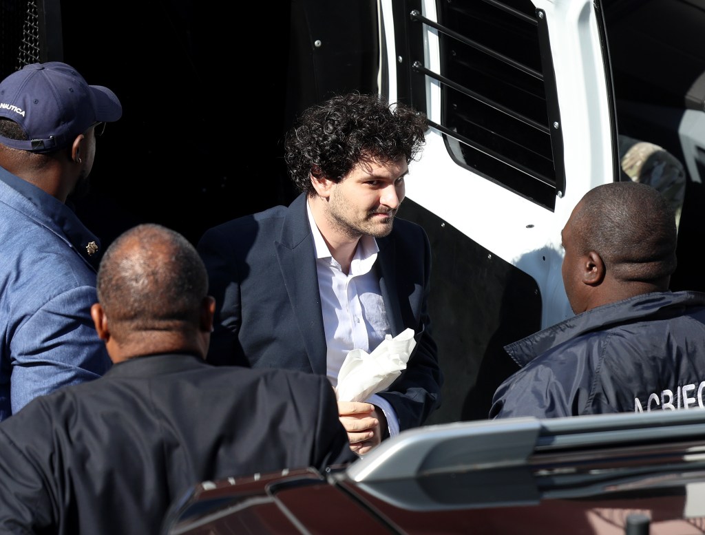 FTX co-founder Sam Bankman-Fried is escorted by corrections officers to the Magistrate's Court in Nassau, Bahamas, on Dec. 21, 2022. (Joe Raedle/Getty Images)