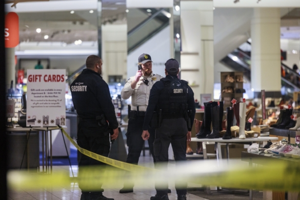 Security officers speak inside a store at the Mall of America in Bloomington, Minn., after reports of shots fired on Friday, Dec. 23, 2022. (Kerem Yücel/Minnesota Public Radio via AP)