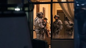 York Regional Police tactical officers stand in the lobby of a condominium building that was the site of a shooting in Vaughan, Ontario. (Arlyn McAdorey/The Canadian Press via AP)