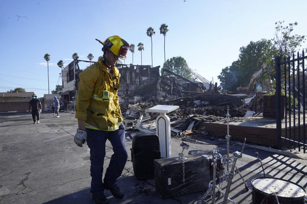 A Los Angeles fireman recovers musicals instruments following a fire at the Victory Baptist Church in Los Angeles, Sunday, Sept. 11, 2022. Authorities launched an arson investigation after a fire destroyed the historic church in South Los Angeles.

Damian Dovarganes | AP