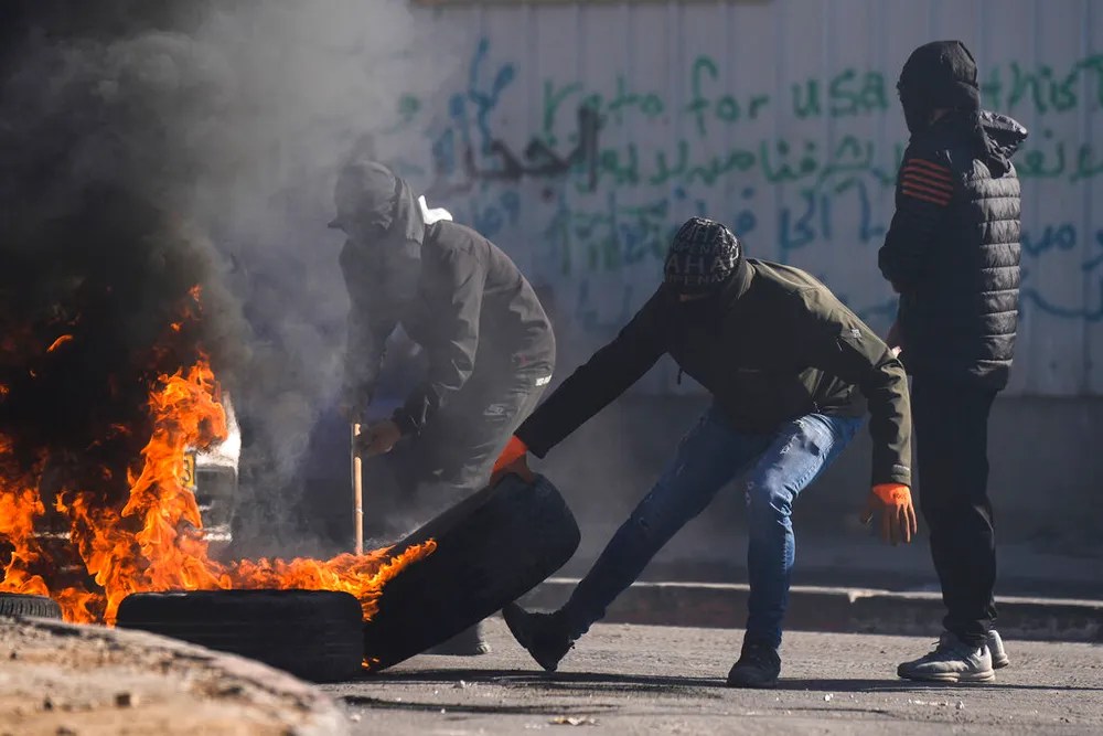 AP Photo/Majdi MohammedPalestinian demonstrators burn tires in a protest against a deadly Israeli army raid in the West Bank town of al-Ram, north of Jerusalem, on January 27, 2023.