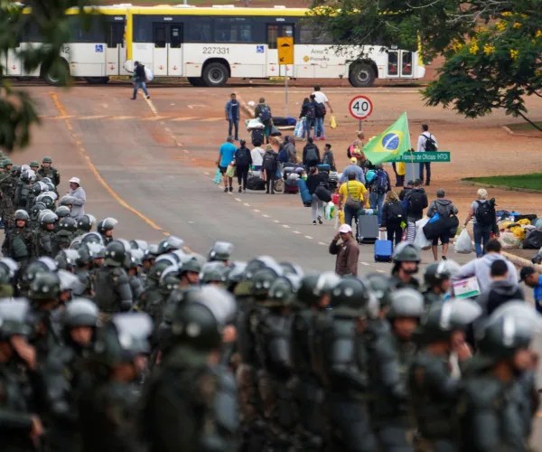 Police officers take position as supporters of Brazil's former President Jair Bolsonaro leave a camp outside the Army headquarters in Brasilia, Brazil, Jan. 9. (Eraldo Peres/AP Photos)
