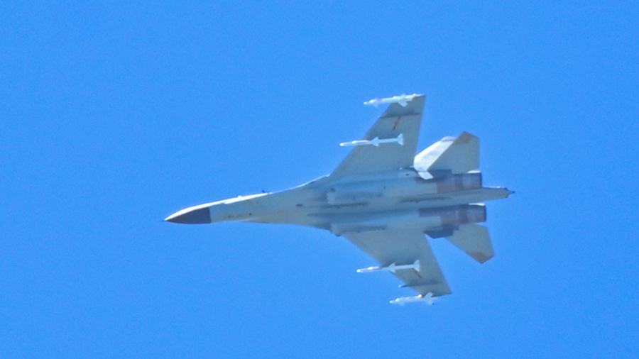 A Chinese military jet flies over Pingtan Island, one of mainland China's closest point from Taiwan, in Fujian Province, China, on Aug. 5, 2022. (Hector Retamal/AFP via Getty Images)