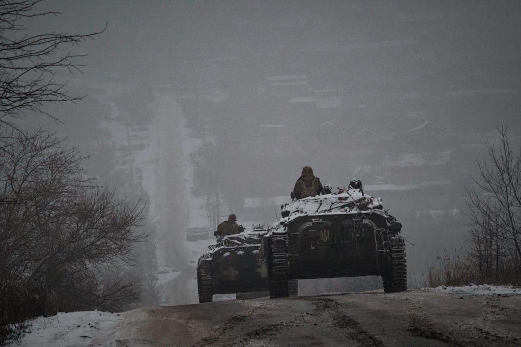 
Ukrainian servicemen ride atop BMP-2 infantry combat vehicles driving down an icy road in the Donetsk region on January 30, 2023, amid the Russian invasion of Ukraine. Photograph:(AFP)