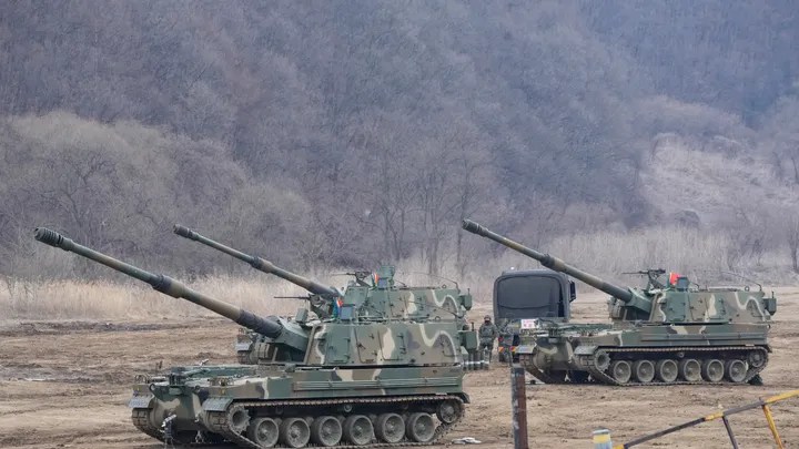 South Korean army soldiers work by K-9 self-propelled howitzers in Paju, South Korea, near the border with North Korea, Thursday, Feb. 16, 2023. (AP Photo/Ahn Young-joon)