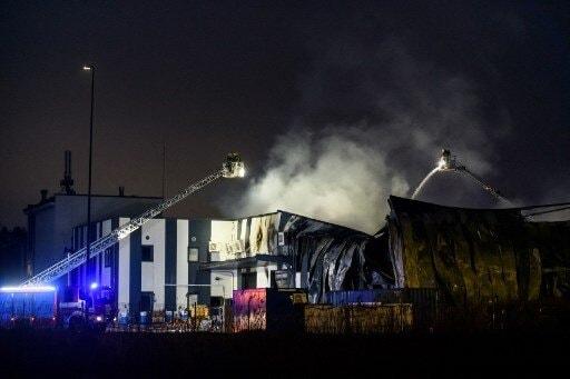 Firefighters extinguish a fire at a drone factory run by US firm Edge Autonomy in Marupe on the outskirts of Latvia's capital Riga on February 7, 2023. AFP
