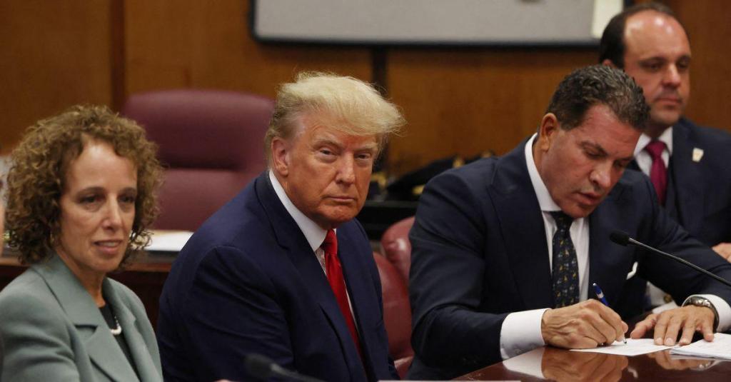  Former U.S. President Donald Trump is accompanied by members of his legal team, Susan Necheles and Joe Tacopina, as he appears in court for an arraignment on charges stemming from his indictment by a Manhattan grand jury, April 4, 2023. REUTERS/Andrew Kelly