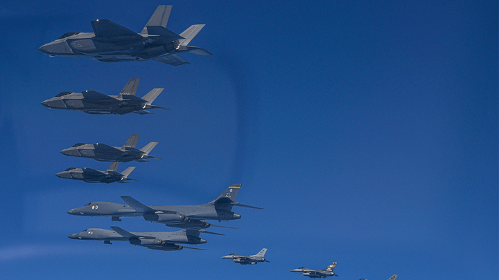 In this photo provided by South Korea Defense Ministry, U.S. Air Force B-1B bombers (bottom left) fly in formation with South Korea's Air Force F-35A fighter jets and U.S. Air Force F-16 fighter jets (bottom right) over the South Korea Peninsula during a joint air drill in South Korea. (South Korea Defense Ministry via AP)
